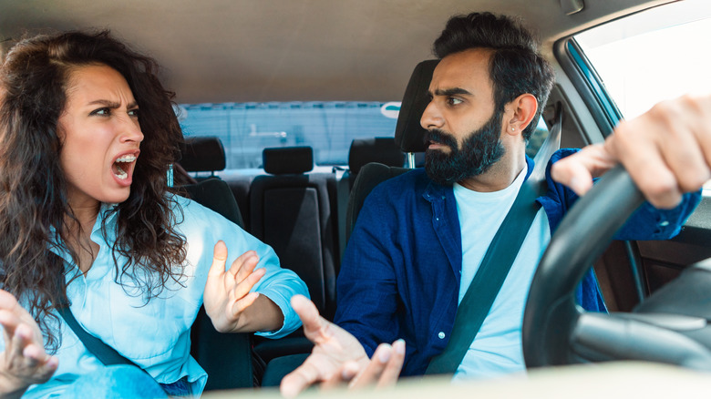 Couple fighting while in the car