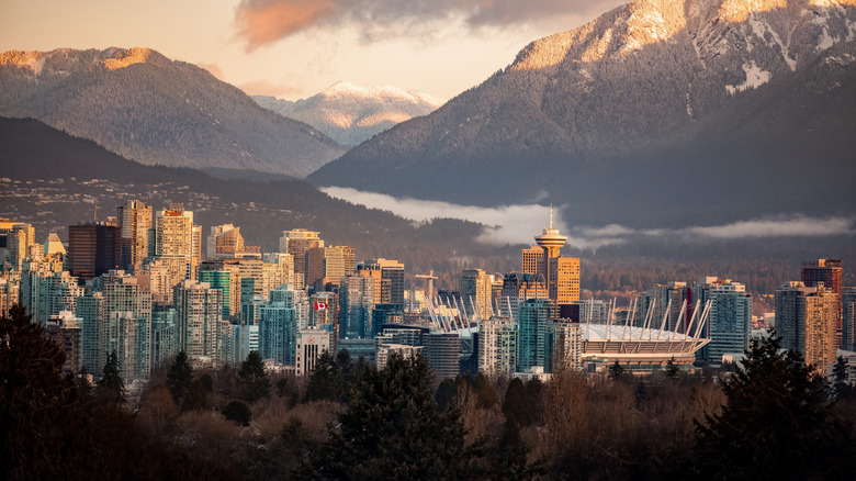 City skyline of Vancouver backed by Rocky Mountains