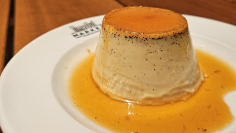 creamy flan on small branded Time Out Market plate