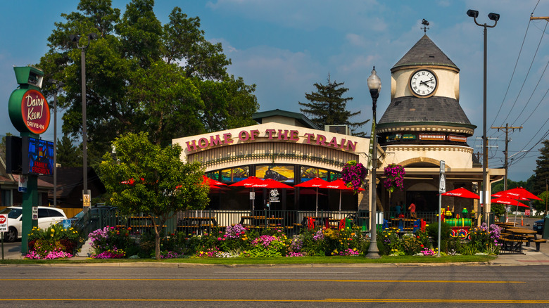 Exterior of eatery, Dairy Keen, with floral arrangements.