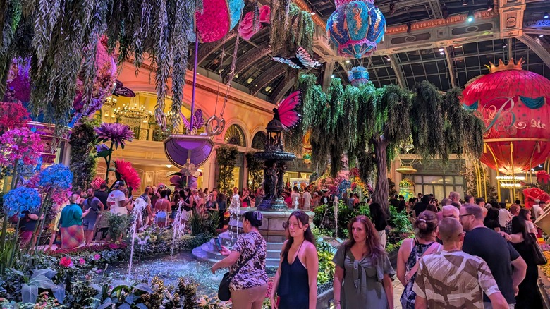 people looking at flower and garden display inside Las Vegas Bellagio Hotel