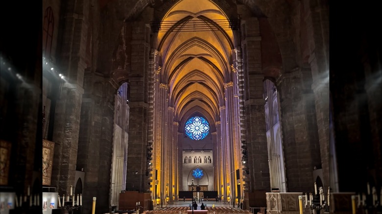 Interior of the Cathedral of St. John the Divine with light pouring in from rosette window