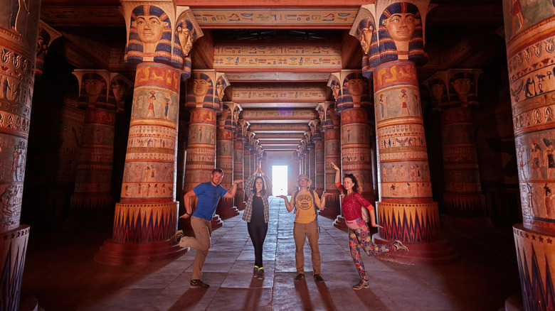 Visitors pose inside the film set of an Egyptian palace