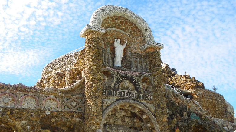 facade of the Grotto of the Redemption with a statue of Jesus on top