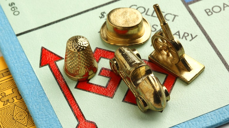 gold Monopoly pieces placed on GO square