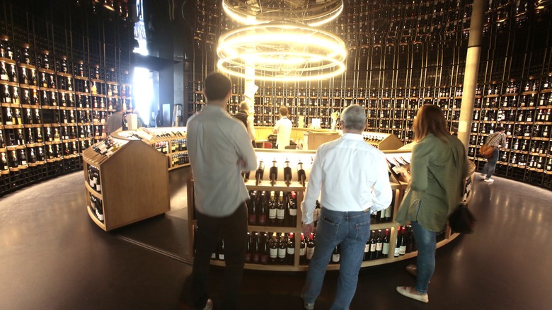 People looking at wine bottles in La Cité du Vin's cellar