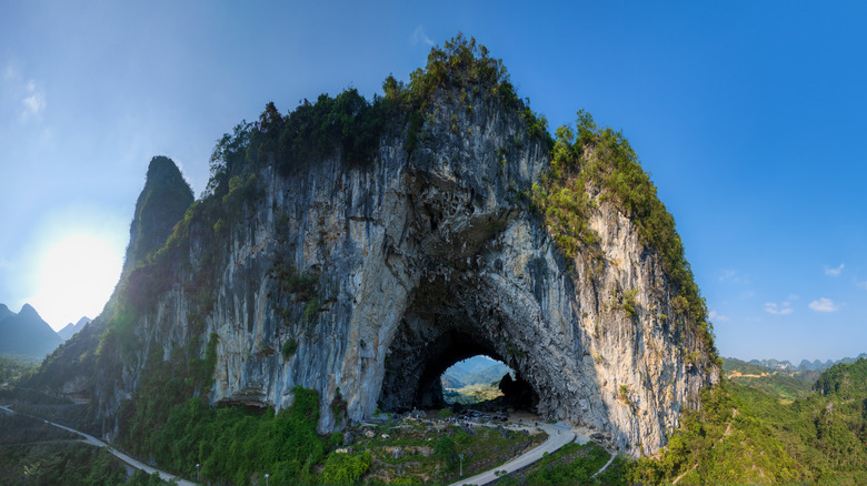 Shegang cave above a road in Fengshan County, China