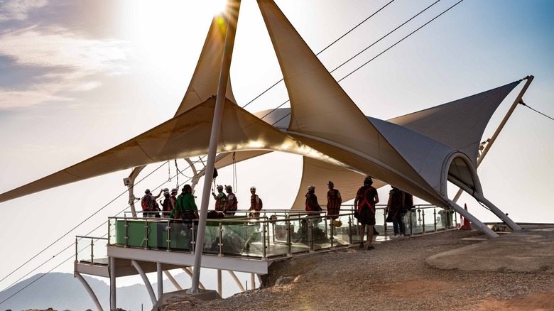 Adventure-seekers get ready to take the longest zipline ride of their iives at the peak of Jebel Jais