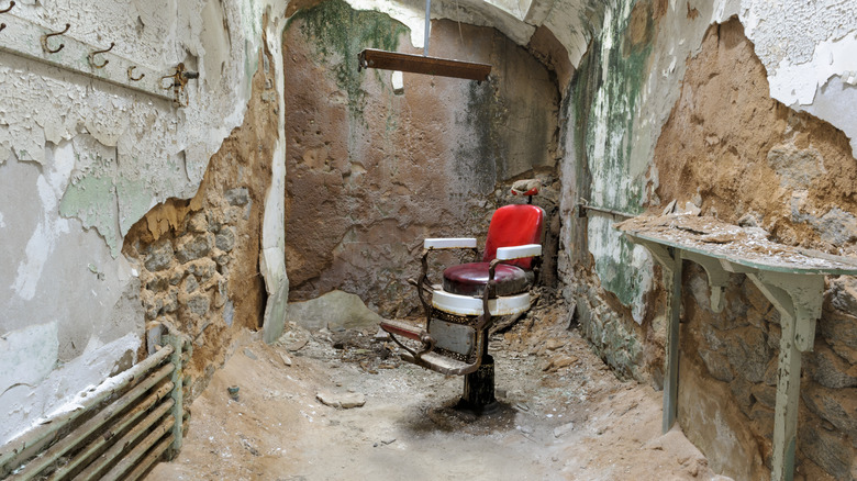 Abandoned barber chair in decaying room in Philadelphia's Eastern State Penitentiary