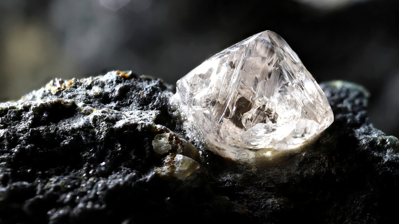 natural diamond half-buried in earth