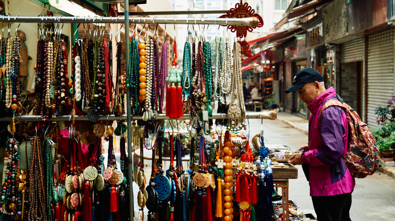 Person shopping at the Upper Lascar Row market near Hollywood Road in Hong Kong