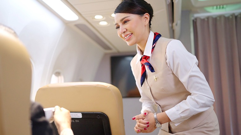 Flight attendant smiling at a passenger