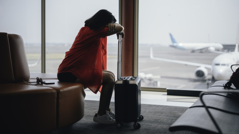 A woman at the airport feeling unwell