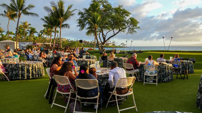 People attending a beachside luau