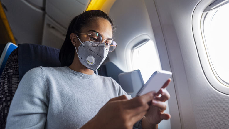 Passenger wearing N95 face mask on plane