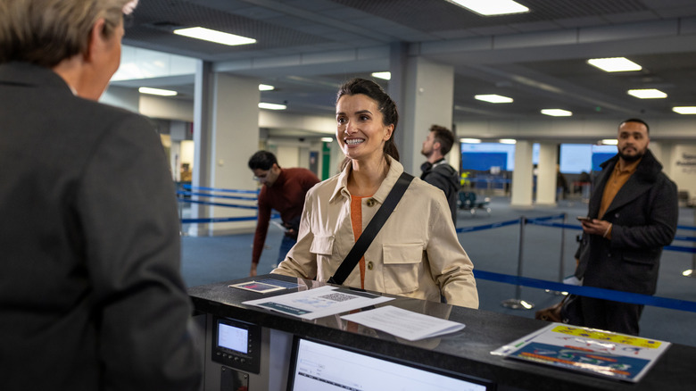 Person presenting paper document copies while traveling