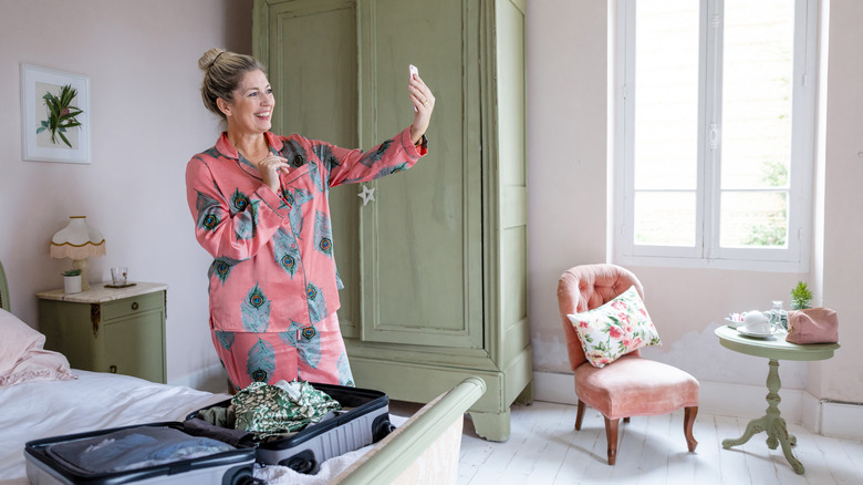 Traveler wearing pajamas in guest room