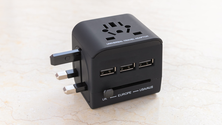 Universal power adapter on plain surface