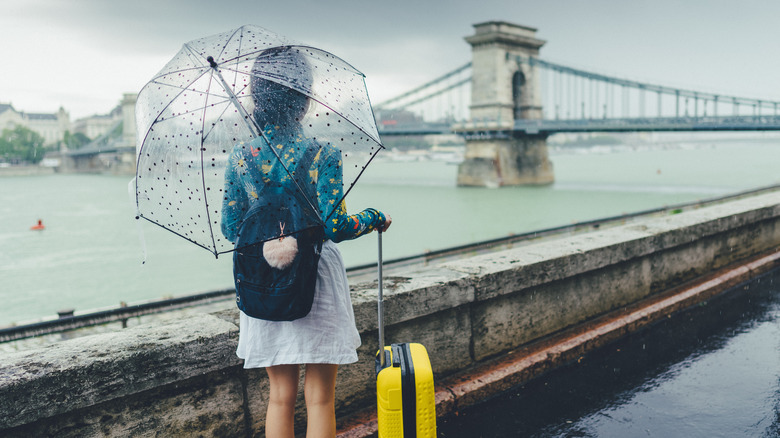 Traveler using an umbrella in Budapest