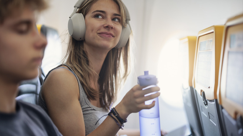 Airplane passenger with travel water bottle