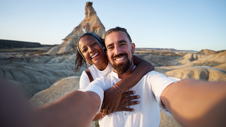 A couple smiling while taking a selfie