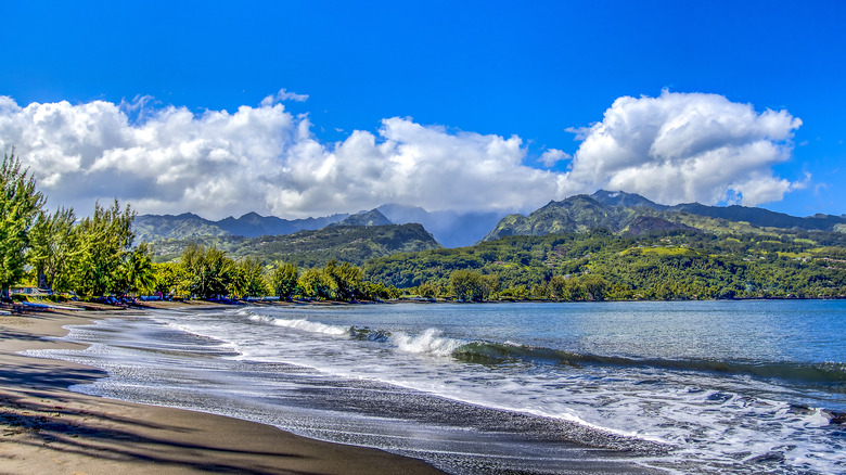 tropical beach mountains in distance