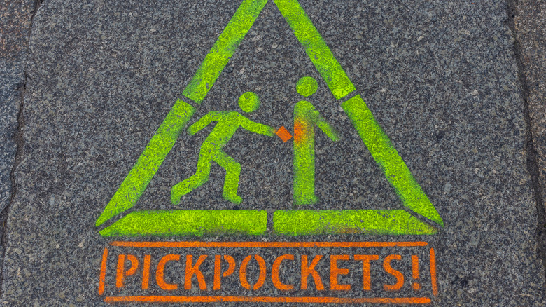 Pickpocket warning on pavement