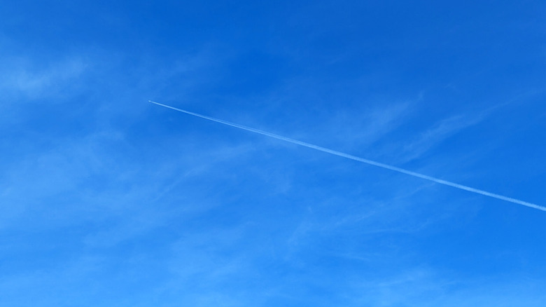 Aeroplane flying through blue sky