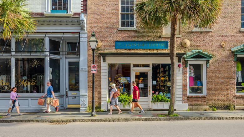 People on palm tree-lined street