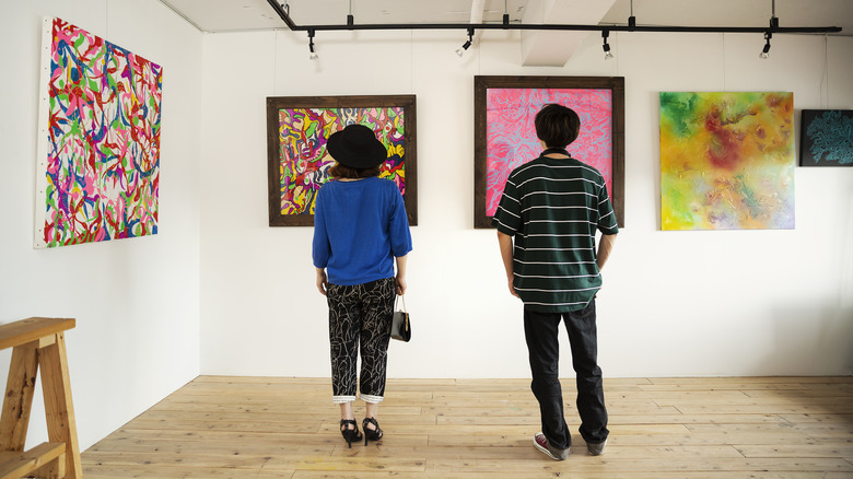 couple in front of paintings