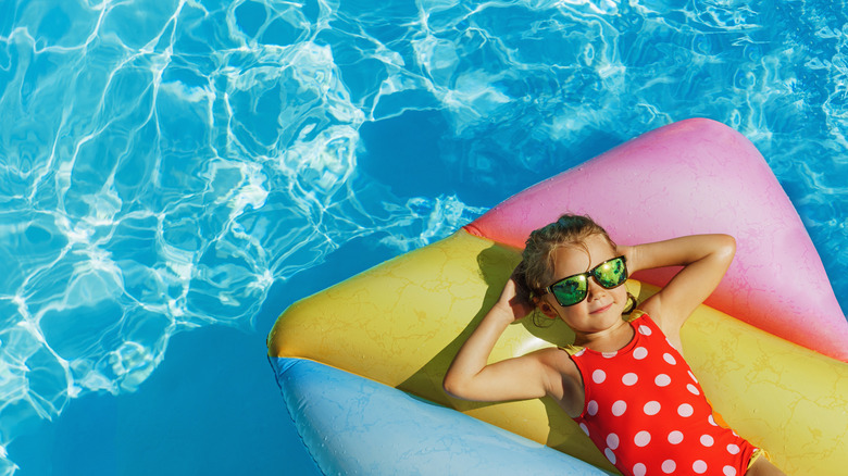 Child in red suit on float