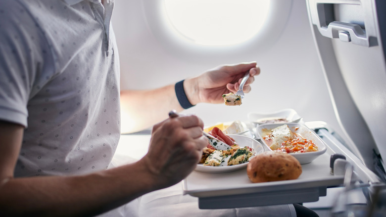 Tray of airplane food being eaten