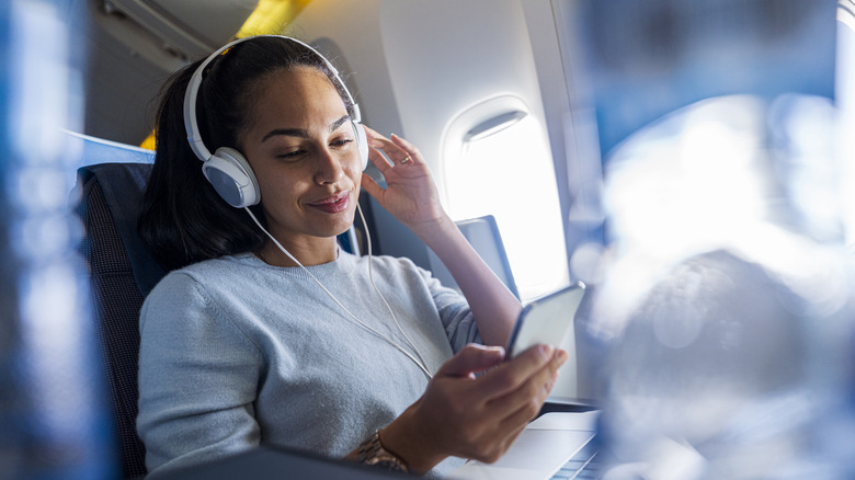 Woman on plane in headphones
