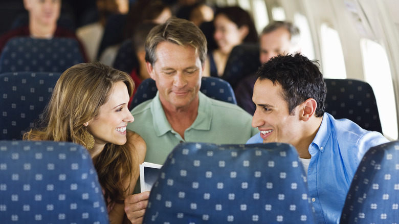 Passengers talking over man
