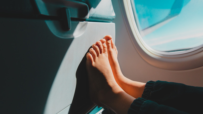 Child's feet on an airplane