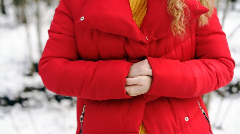 A woman wearing a thick red jacket.