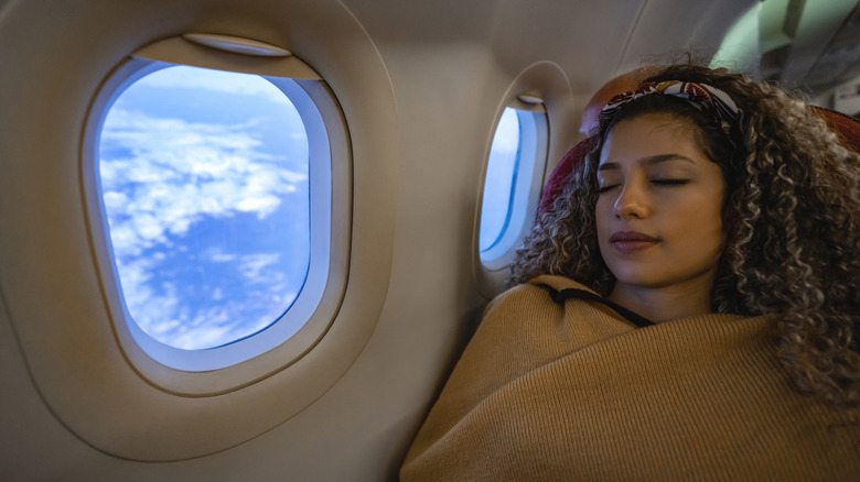 Woman wearing travel pillow