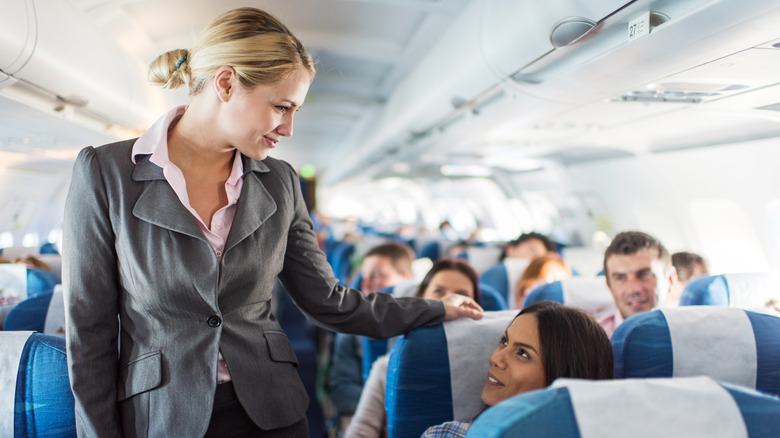 smiling passenger with flight attendant 