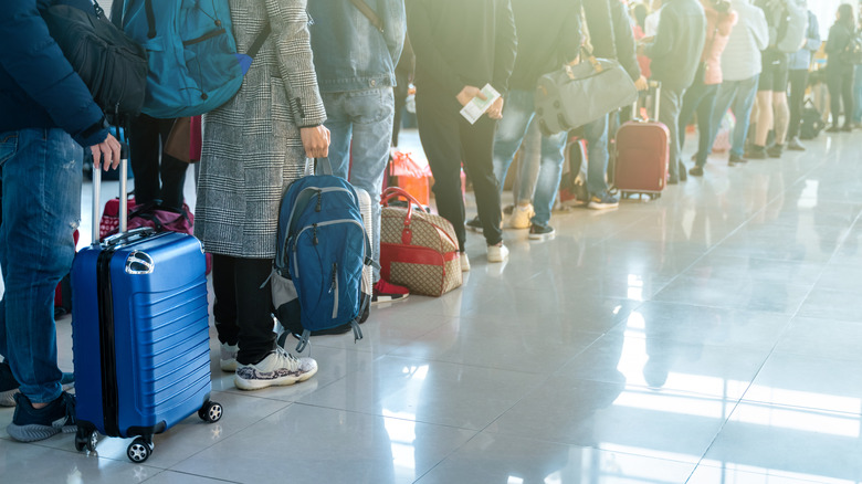 A line of passengers waiting to board a flight