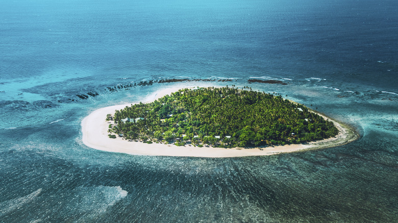 Aerial view of the heart-shaped island of Tavarua off the coast of the mainland