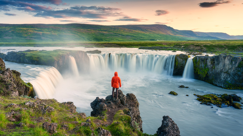 Tourist in Iceland overlooking waterfalls