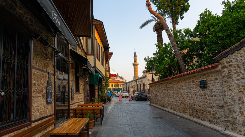 Cobblestone street in Antalya with view of a minaret in Turkey