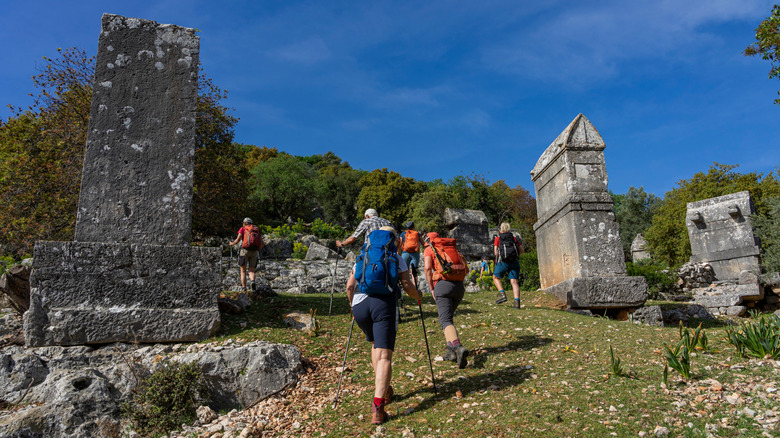 People hiking through ancient ruins on the Lycian Way in Turkey