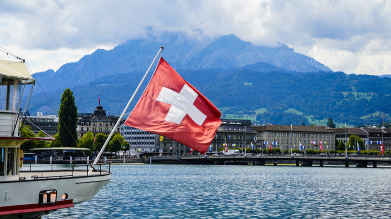 Swiss flag flying off a boat on a lake in Switzerland