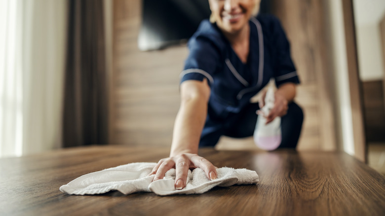 A woman wiping a table