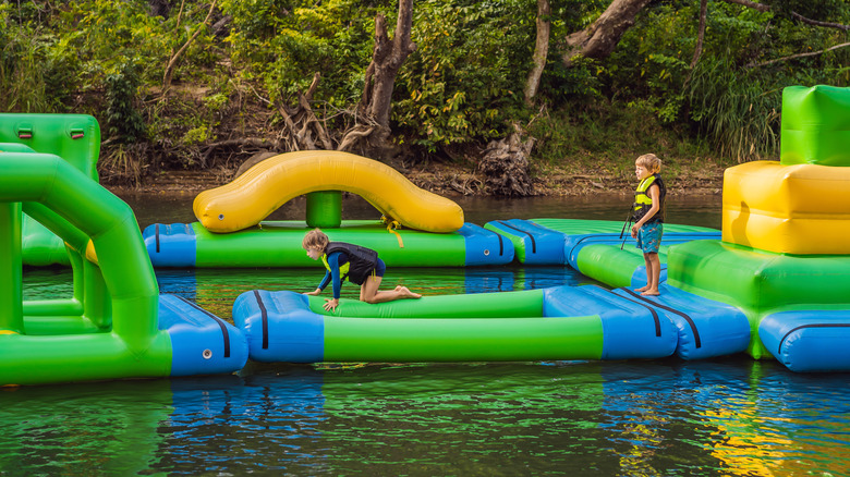 Children on inflatable lake toys