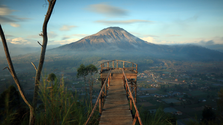 Wooden viewing bridge without people with view of Kintamani volcano in Bali