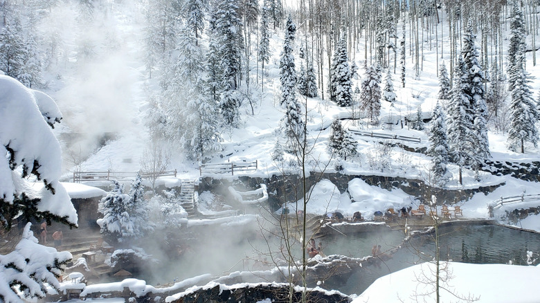 Steamy hot spring in a snowy forest in Steamboat Springs, Colorado