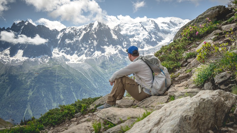 Hiker sitting and enjoying mountain view