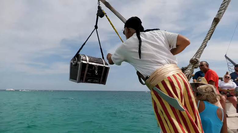 Pirate pulling treasure from ocean